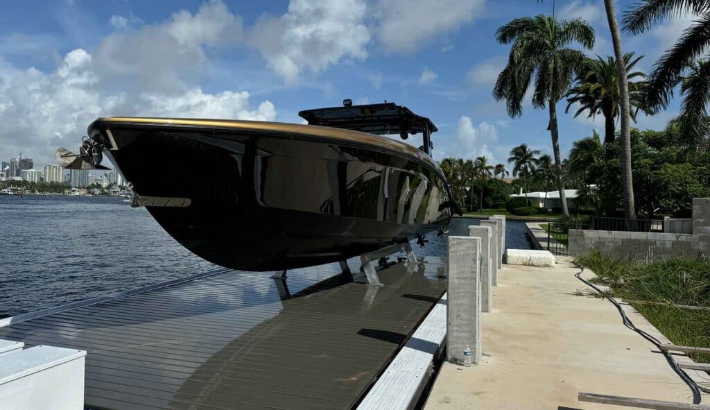 Black and gold boat raised on a custom platform boat lift on the Intracoastal in Fort Lauderdale.