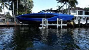 Blue Lamborghini yacht raised on an 8-post boat lift in Fort Lauderdale.