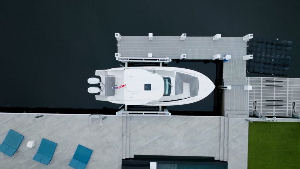 Top-down view of a white center console on a 4-post boat lift.