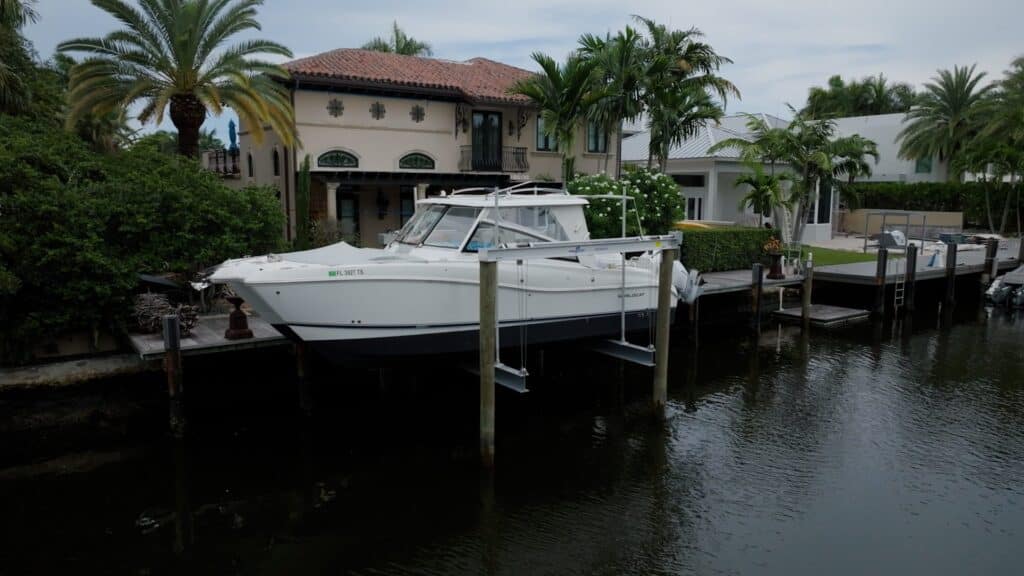 White express cruiser raised on a 4-post boat lift.