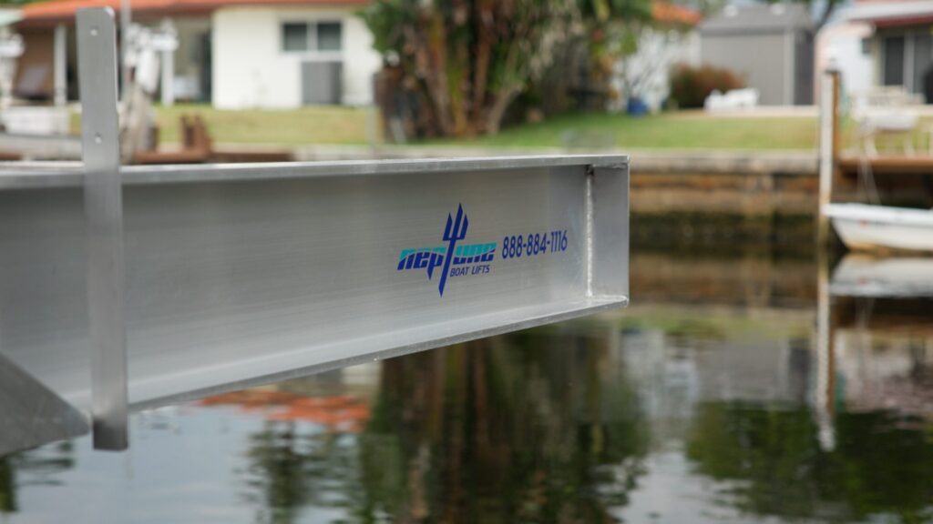Close-up of an aluminum Neptune elevator boat lift arm with the Neptune logo.
