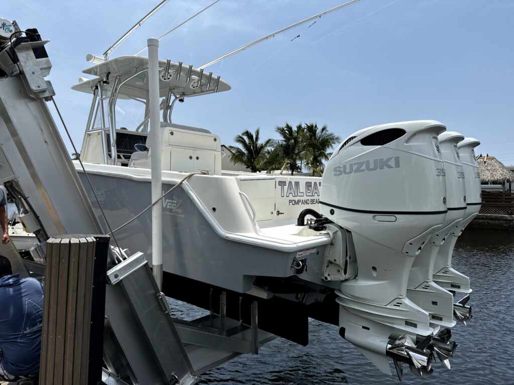 Elevator boat lift with triple outboards in pompano beach.