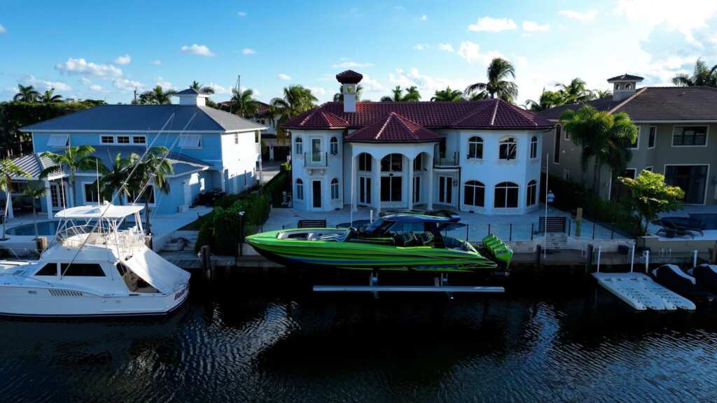 Elevator boat lifts with a performance boat and sportfish.