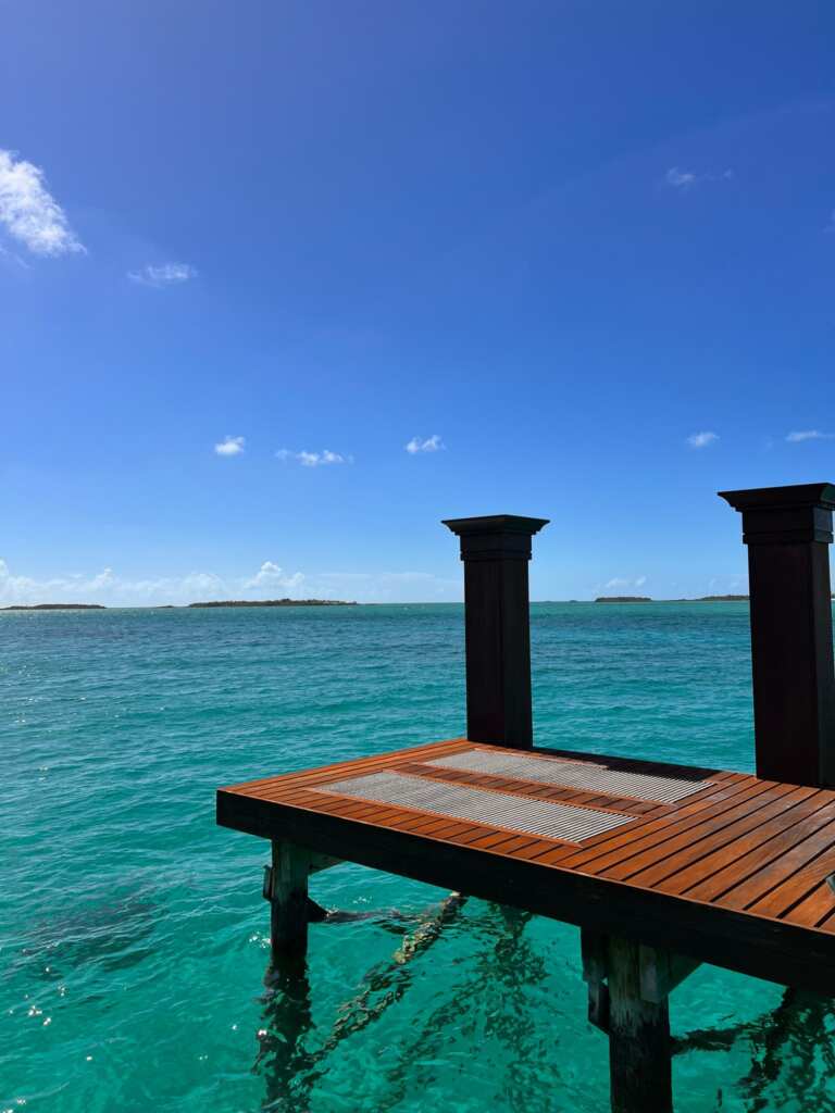 Hardwood dock over turquoise water.